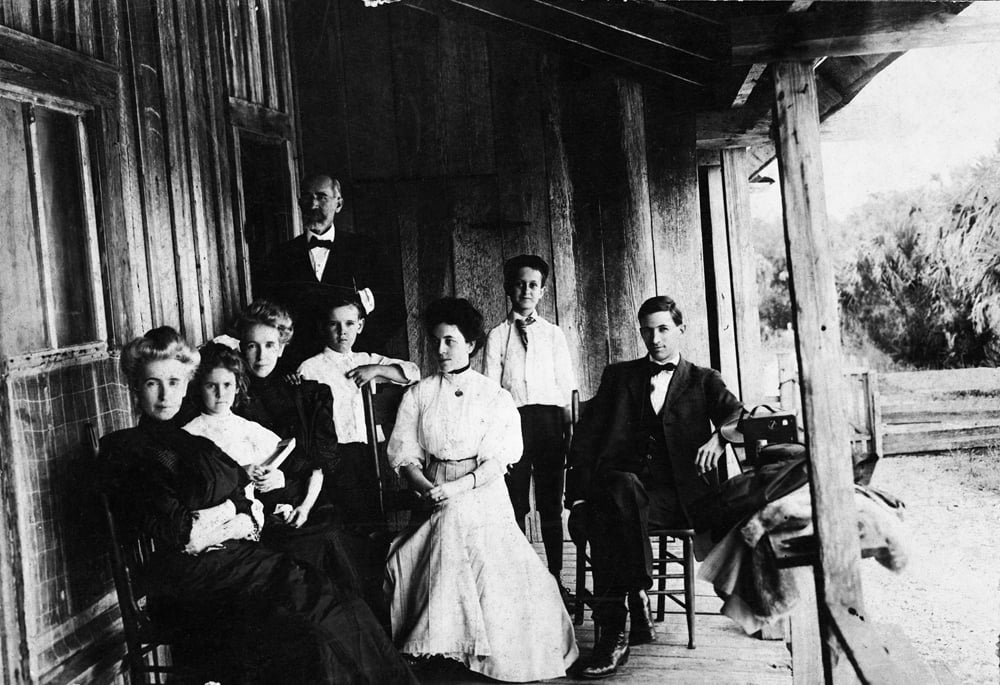 On the porch of the caretaker’s house. 1907. Black & white photonegative, 4 x 5 in. State Archives of FL, Florida Memory. L-R: Mary Weedon Hazen, May McNeer, Isabelle Weedon McNeer, Dr. Leslie W. Weedon, Weedon McNeer, Mrs. Carhart, Harry Lee Weedon, Mr. Carhart