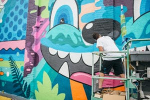 Muralist Greg Mike at work on 915 1st Ave N