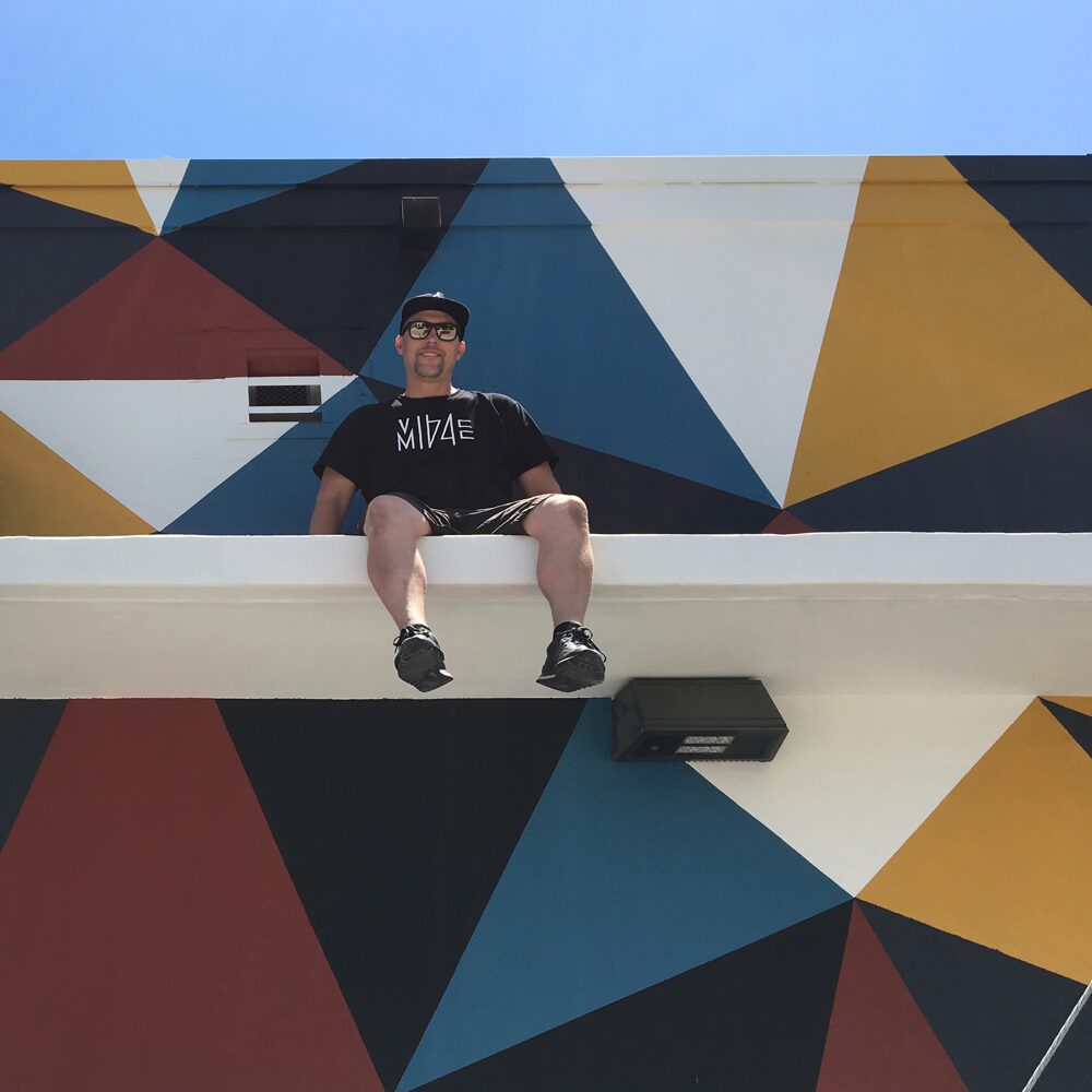 Chad Mize in front of his just finished mural in the Wynwood neighborhood of Miami. Photo by Steve Aikens.