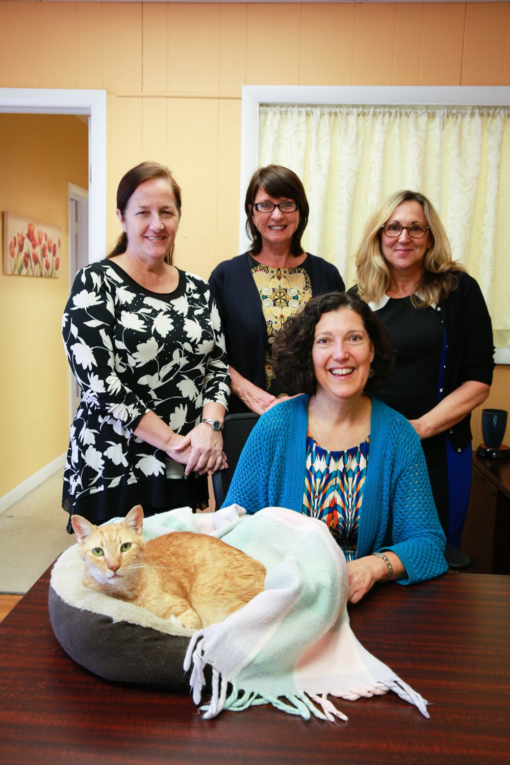Top, From left to right: Susan Bauer (Office Manager and Probate Paralegal), Patricia Hagood (Client Services Coordinator), and Diane Dougherty (Client Services Manager). Seated in front, Stephanie Edwards (Attorney), and Winston (Client Friend / up-and-coming Model). Photo by Emily Canfield.