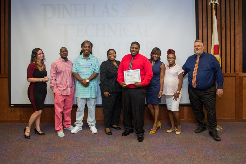 Keondre receives his certification at Pinellas Technical College. From Left to Right: Heather Nix, Program Coordinator - Second Chance Tiny Homes, Antonio Crockett, Instructor/Mentor - Second Chance Tiny Homes, JacQuis Monroe, Instructor/Mentor - Second Chance Tiny Homes, Dr. Antelia Campbell, Assistant Director Evenings – Pinellas Technical College, Keondre Robinson, Graduate – Second Chance Tiny Homes, Dr. Kanika Tomalin, Deputy Mayor and City Administrator of St. Petersburg, Terrika Burton-Hobbs, Workforce Empowerment Specialist – Pinellas Ex-Offender Re-Entry Coalition, Michael Jalazo, Executive Director/CEO – Pinellas Ex-Offender Re-Entry Coalition