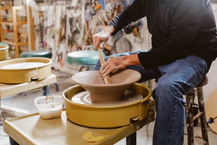Charlie Parker throwing a bowl on the pottery wheel. Photo by Kristina Holman