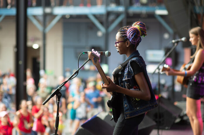 Mia hits the Jannus stage and plays her five-day-old song to a large crowd. Photo by Whitnie Williams