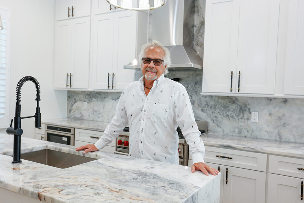 Tom O’Brien in kitchen of main residence with beautiful Brazilian stone. Photo by Kristina Holman